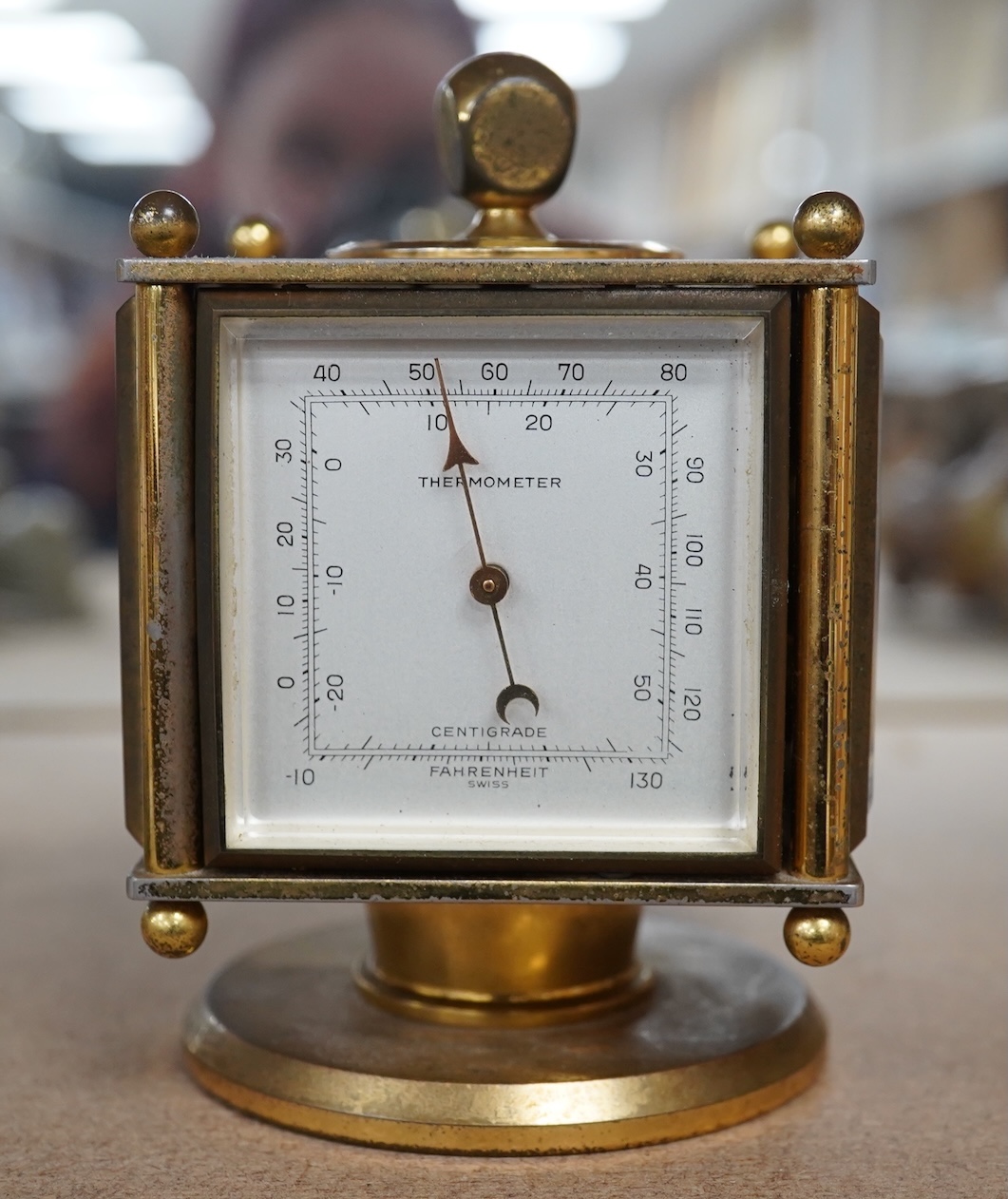 An Imhof brass combination clock, hydrometer, barometer and thermometer, 12cm high. Condition - fair